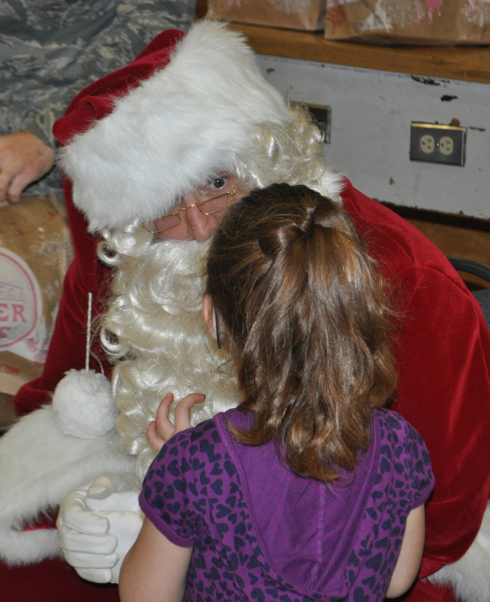 TRAVIS AIR FORCE BASE, Calif. --"Really?" was Santa's surprised response to the holiday wish from this little red-haired girl, who spoke animatedly to him for several minutes. Santa, aka Chief Master Sgt. Mark Kloeppel, has been visiting Travis area kindergarten classes for a number of years, as part of the 349th AMW's Operation Teddy bear. He says he is always surprised by some of the unselfish gift requests of these five and six-year olds. They often ask for something for the family, even a job for an unemployed dad, and are always filled with joy as they receive a gift bag from him, that includes a Teddy bear. (U.S. Air Force photo/Senior Master Sgt. Ellen Hatfield) (U.S. Air Force photo/Senior Master Sgt. Ellen Hatfield)