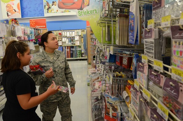 JOINT BASE PEARL HARBOR-HICKAM, Hawaii --The Honolulu Police Department invited members of the 624th Aeromedical Staging Squadron to join them in their annual “Shop With a Cop” program for disadvantaged children on Saturday Dec. 22, at the Keeaumoku Walmart. The program teams the children with a volunteer who helps them pick out gifts sponsored by the HPD and the participating store. (U.S. Air Force photos by Master Sgt. Daniel Nathaniel)