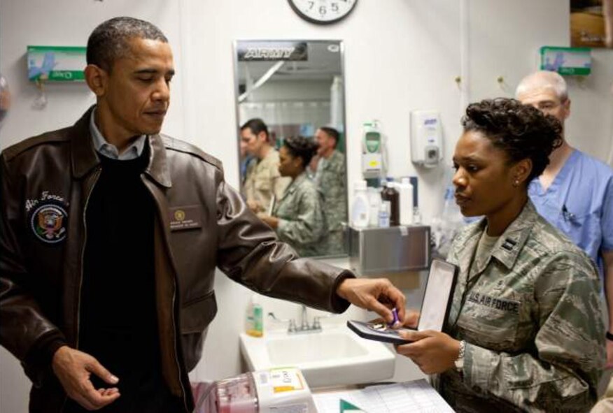 Capt. Bridgette Scott, right, hands President Barack Obama a Purple Heart medal during the President’s recent visit to Bagram Air Base in Afghanistan. Scott is the medical readiness officer for the 188th Medical Group. Scott was deployed for one year to Bagram, where she functioned as the executive officer for the 455th Expeditionary Medical Group. Capt. Scott and Col. Paul Norris, 188th Med Group commander were both recognized at a commander’s call Dec. 1 for receiving Bronze Stars while deployed to Afghanistan. (U.S. Air Force photo) 