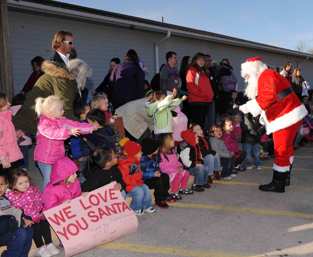 Children enrolled in the Youth and Family Services program gathers outside to welcome the arrival of Santa Claus at the Youth and Family Services Center during the 28th Operations Group Angel Tree gift program in Rapid City, S.D., Dec. 18, 2012. This is the sixth year that the 28th Operations Group has invited Santa to the YFS Center to help provide gifts to children in our local community. (U.S. Air Force photo by Airman 1st Class Anania Tekurio/Released) 