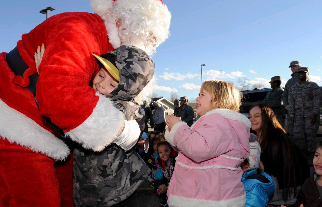 Santa Claus greets children at the Youth and Family Services Center during the 28th Operation Group Angel Tree gift program in Rapid City, S.D., Dec. 18,2012. Children enrolled in the YFS Child Care program welcomed Santa outside and invited him into their classrooms where he gave them each a present. (U.S. Air Force photo by Airman 1st Class Anania Tekurio/Released)