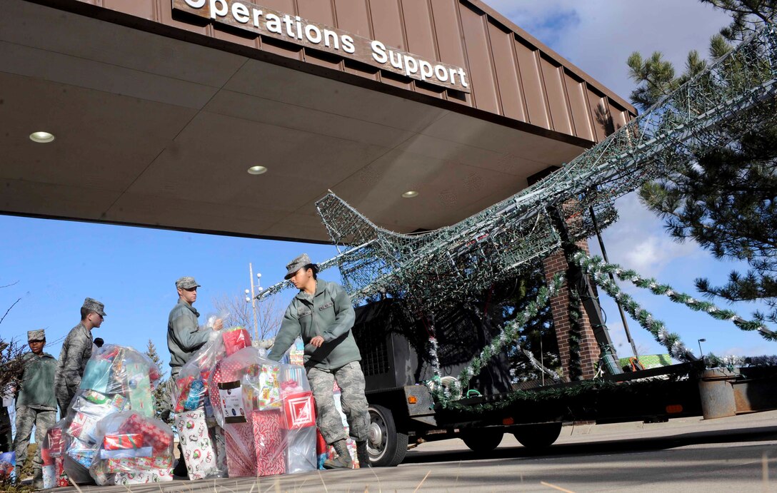 Airmen from the 28th Operations Group load gifts onto a B-1 bomber parade float as they prepare to deliver them to the children at the Youth and Family Services center in Rapid City, S.D., as part of the Angel Tree gift program at Ellsworth Air Force Base, S.D., Dec. 18, 2012. The Angel Tree gift program provides an opportunity for Airmen to make a difference in the lives of families in the Black Hills community. (U.S. Air Force photo by Airman 1st Class Anania Tekurio/Released)