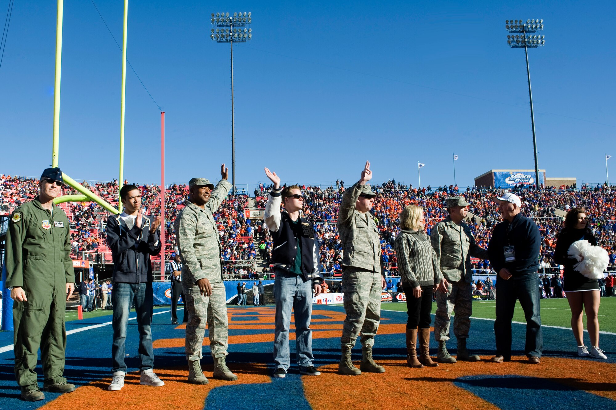 Nellis and Creech Air Force Base leadership are introduced during the Maaco Bowl Dec. 22, 2012, in Las Vegas. Leadership were there to represent and support more than 250 Nellis and Creech Airmen who volunteered to hold the American flag for the opening ceremony. (U.S. Air Force photo by Airman 1st Class Christopher Tam)
