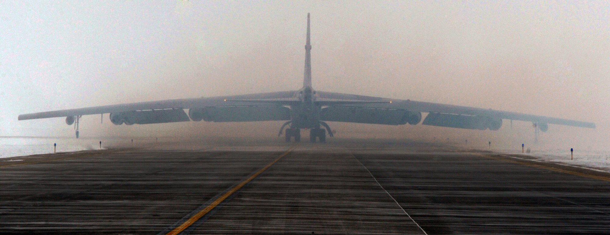 MINOT AIR FORCE BASE, N.D. -- A B-52H Stratofortress taxi’s down the runway prior to take-off here, Dec. 17. The flight would include special guest, Lt. Col. John Dunlap, 5th Bomb Wing director of staff-- it would be his ‘fini’ flight. The 'fini' flight is an Air Force tradition that can be traced back to the Vietnam War, when aircrews celebrated after completing 100 combat missions. (U.S. Air Force photo/Senior Airman Brittany Y. Auld)   