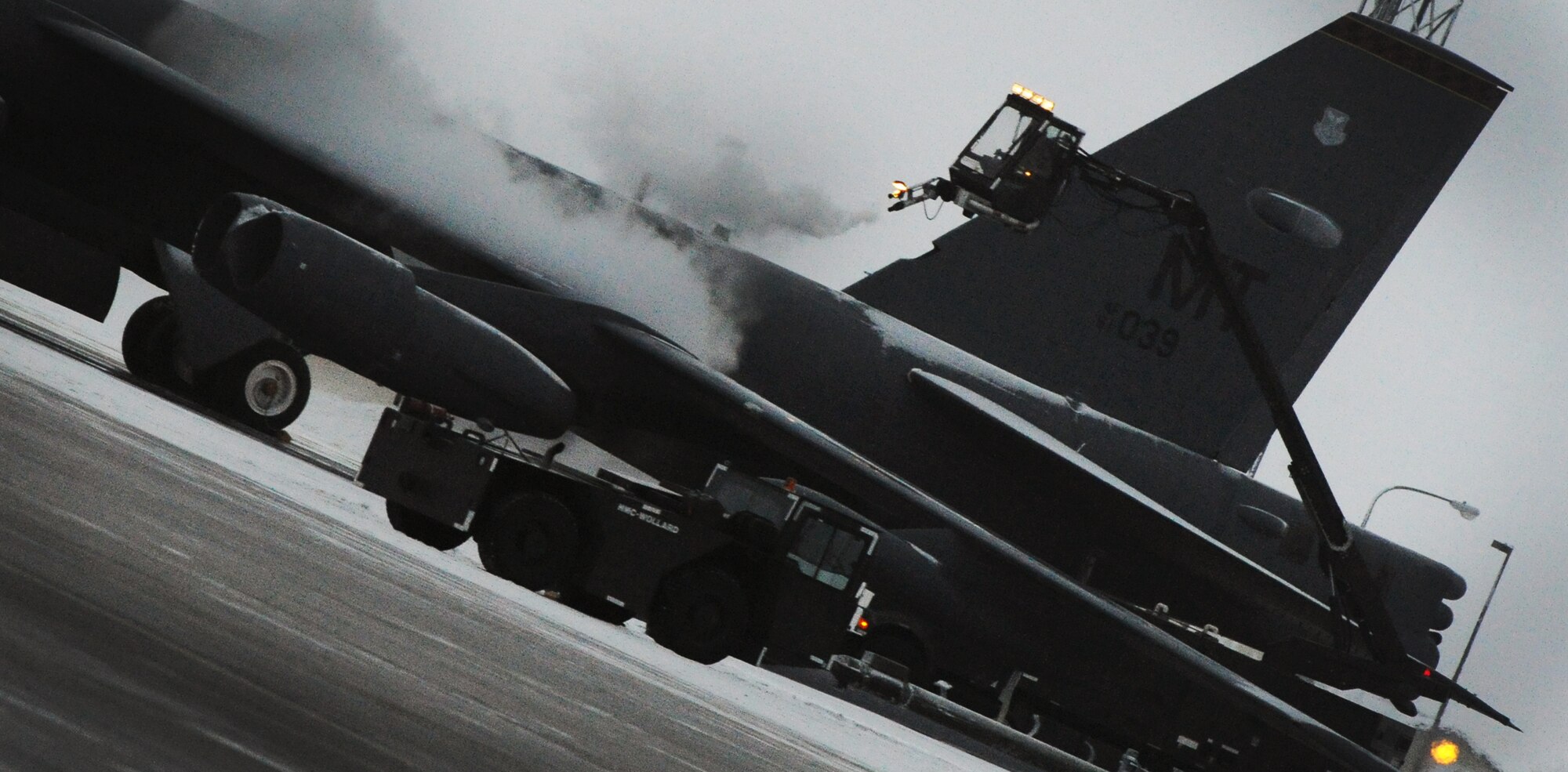 MINOT AIR FORCE BASE, N.D. -- A crane operator from the 5th Aircraft Maintenance Squadron, de-ices a B-52H Stratofortress here Dec. 17. De-icing is a process in which liquid solutions are sprayed onto an aircraft during the winter months to both defrost and prevent future precipitation from freezing. (U.S. Air Force photo/Senior Airman Brittany Y. Auld)