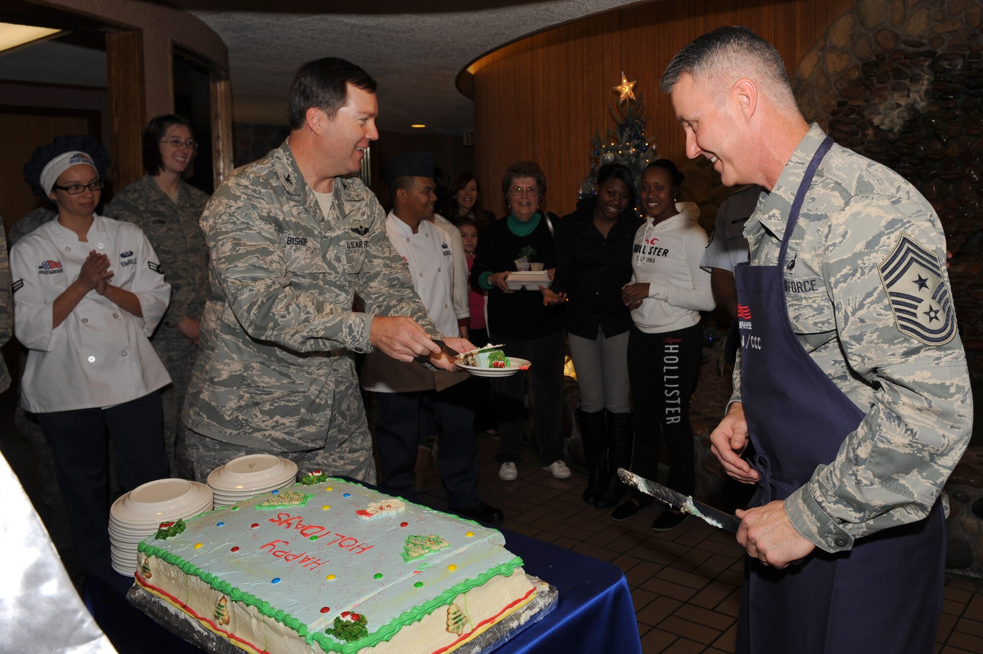 U.S. Air Force Col. Darren Bishop, 99th Mission Support Group commander, and Chief Master Sgt. Vincent Marler, 99th Air Base Wing command chief, serve cake at the Mountain View dining facility Dec. 25, 2012, at Nellis Air Force Base, Nev. Each year, Nellis AFB prepares a Christmas lunch open to active duty, guard, reserve and retired military members and their families. (U.S. Air Force photo by Staff Sgt. William P. Coleman)

  

