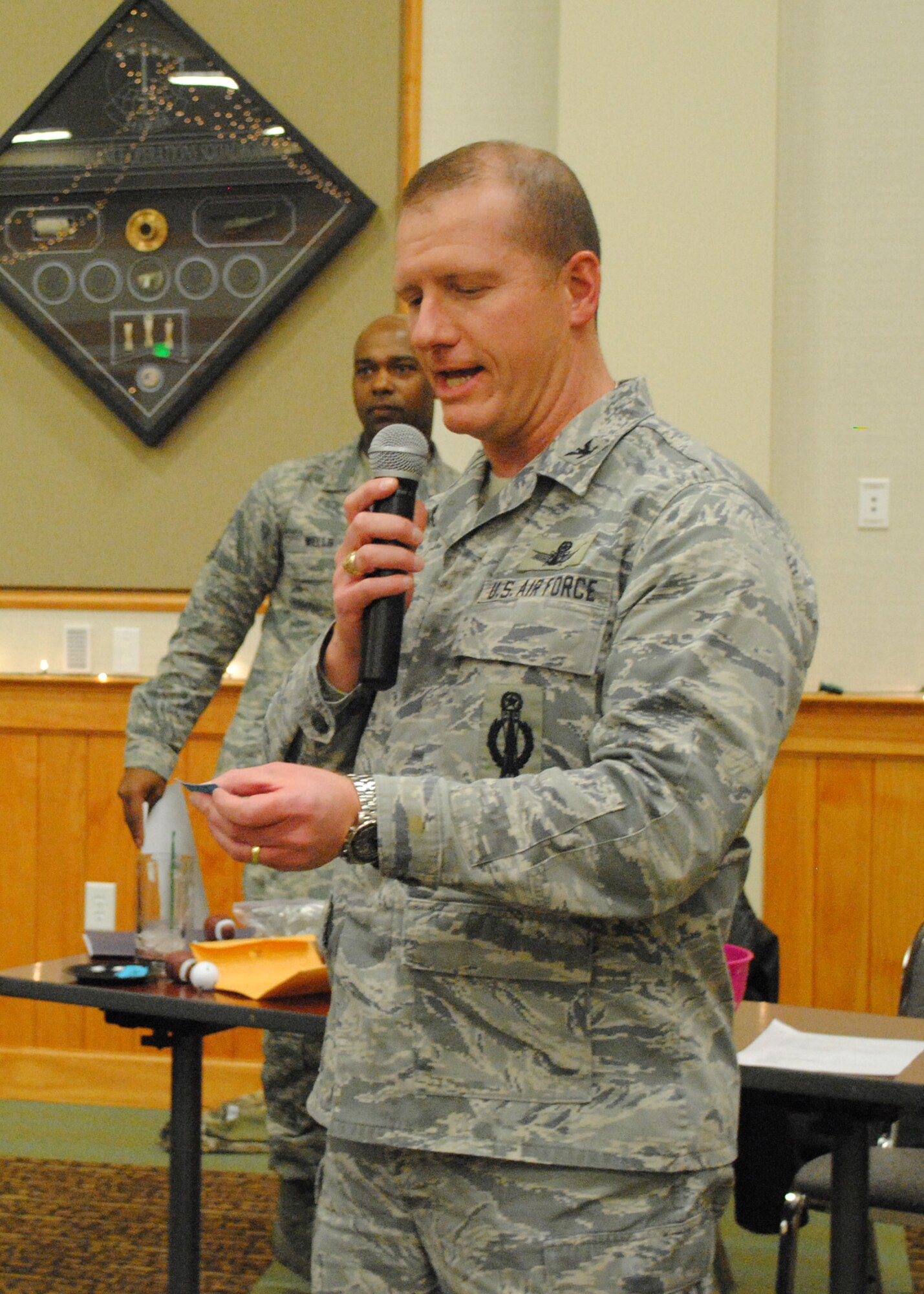 Col. Robert Stanley, 341st Missile Wing vice commander, calls the grand prize raffle ticket number at the OHC Wrap-Up Party at the Grizzly Bend on Dec. 12. Senior Airman Alexander Stinefast, 341st CES member, was named the grand prize winner and received a trip for two to anywhere in the U.S. valued at $1,500. (U.S. Air Force photo/Airman 1st Class Katrina Heikkinen)