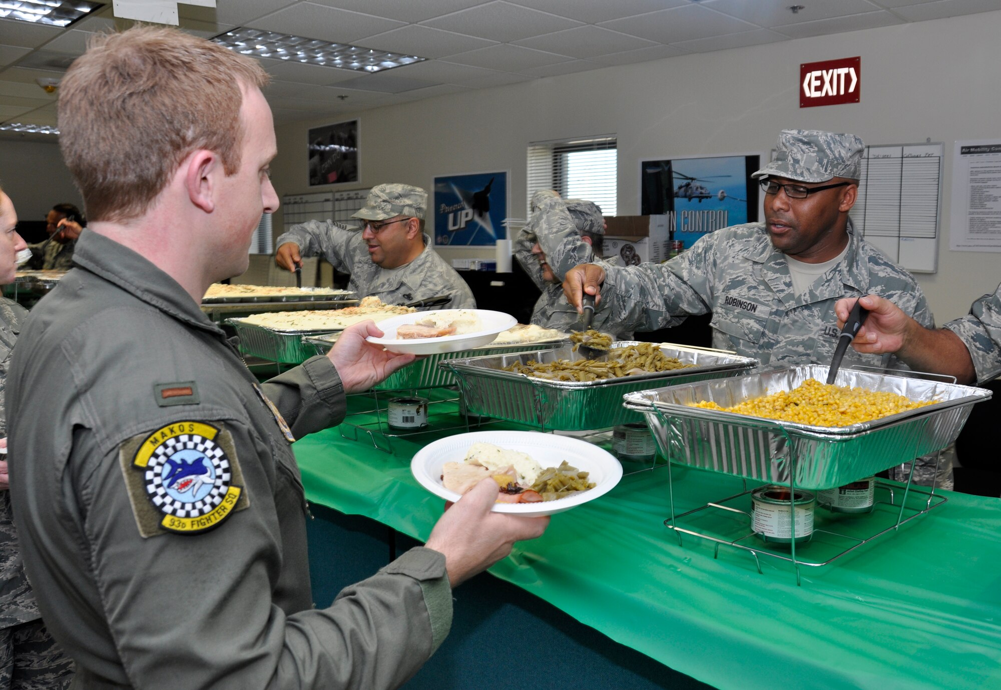 Chief Master Sgt. Katdo Robinson, 482nd Maintenance Squadron superintendent, dishes out a helping of food to 2nd Lt. Tyler Farrell, 482nd Fighter Wing, during the 482nd FW Unity Feast holiday dinner, Dec. 19. (U.S. Air Force photo/Senior Airman Jacob Jimenez)