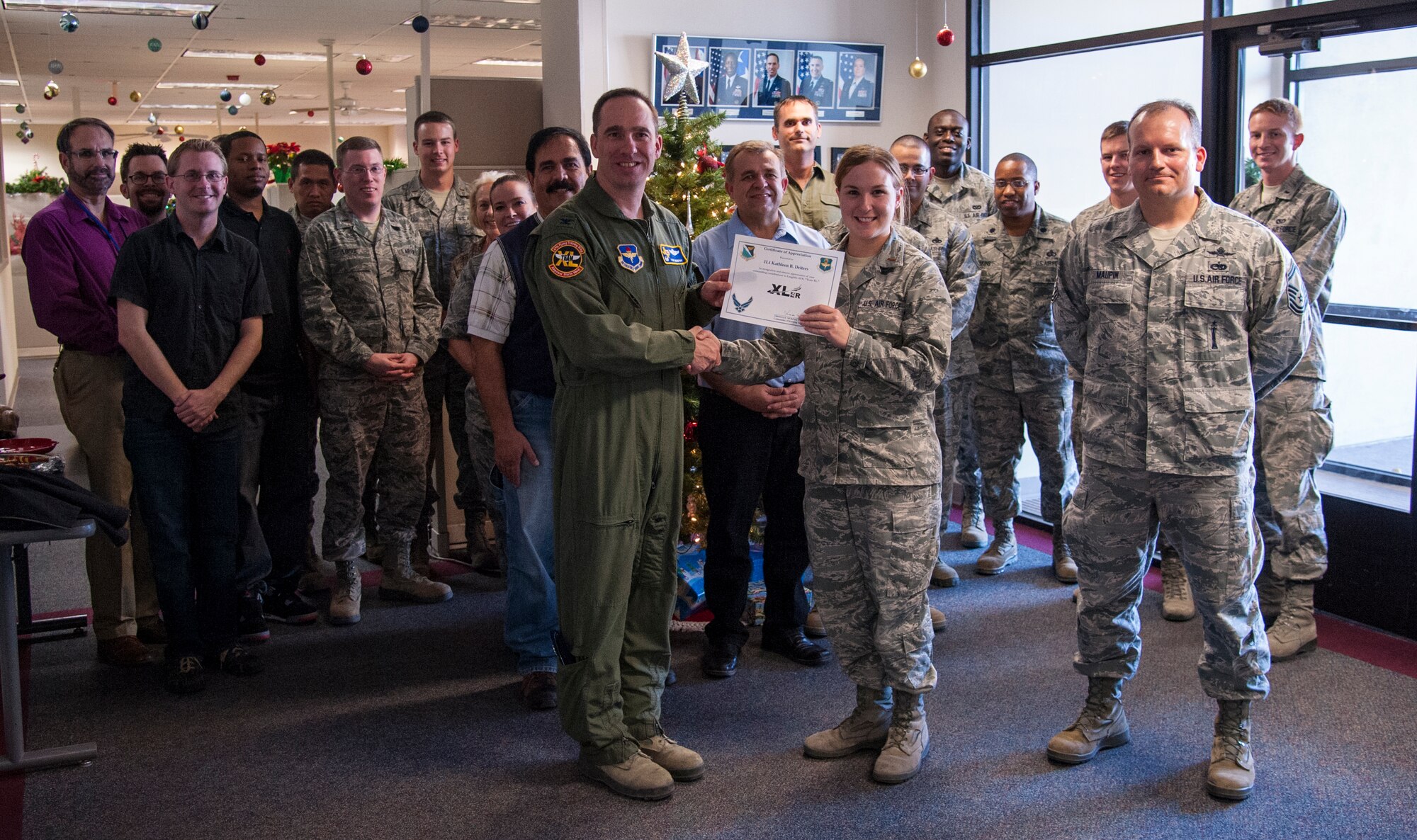 2nd Lt. Kathleen Deiters, 47th Civil Engineer Squadron environmental engineer, poses with Col. Tom Murphy, 47th Flying Training Wing commander, and Senior Master Sgt. Shane Maupin, 47th Mission Support Group superintendent, after being presented the XLer of the Week Award at Laughlin Air Force Base, Texas, Dec. 19, 2012. The XLer is a weekly award chosen by wing leadership and given to those who consistently make outstanding contributions to Laughlin and their unit. (U.S. Air Force photo/Airmen 1st Class Nathan Maysonet)