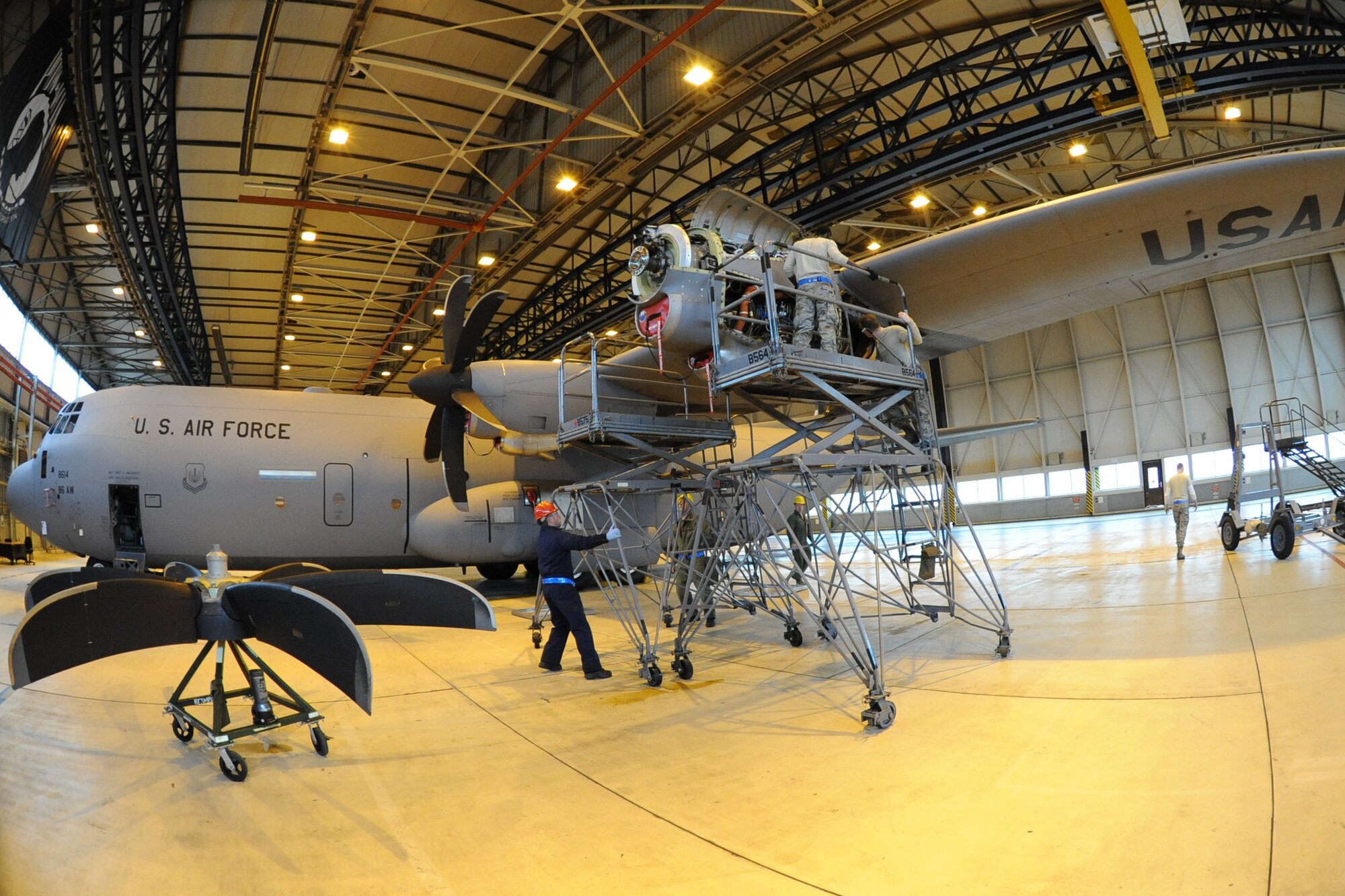 Members of the 86th Aircraft Maintenance Squadron prepare to change an engine on a C-130J, Ramstein Air Base, Germany, Jan. 18, 2012. The engine was damaged by a metal fragment and will take around eight hours to repair. (U.S. Air Force photo/Airman 1st Class Caitlin O-Neil-McKeown)