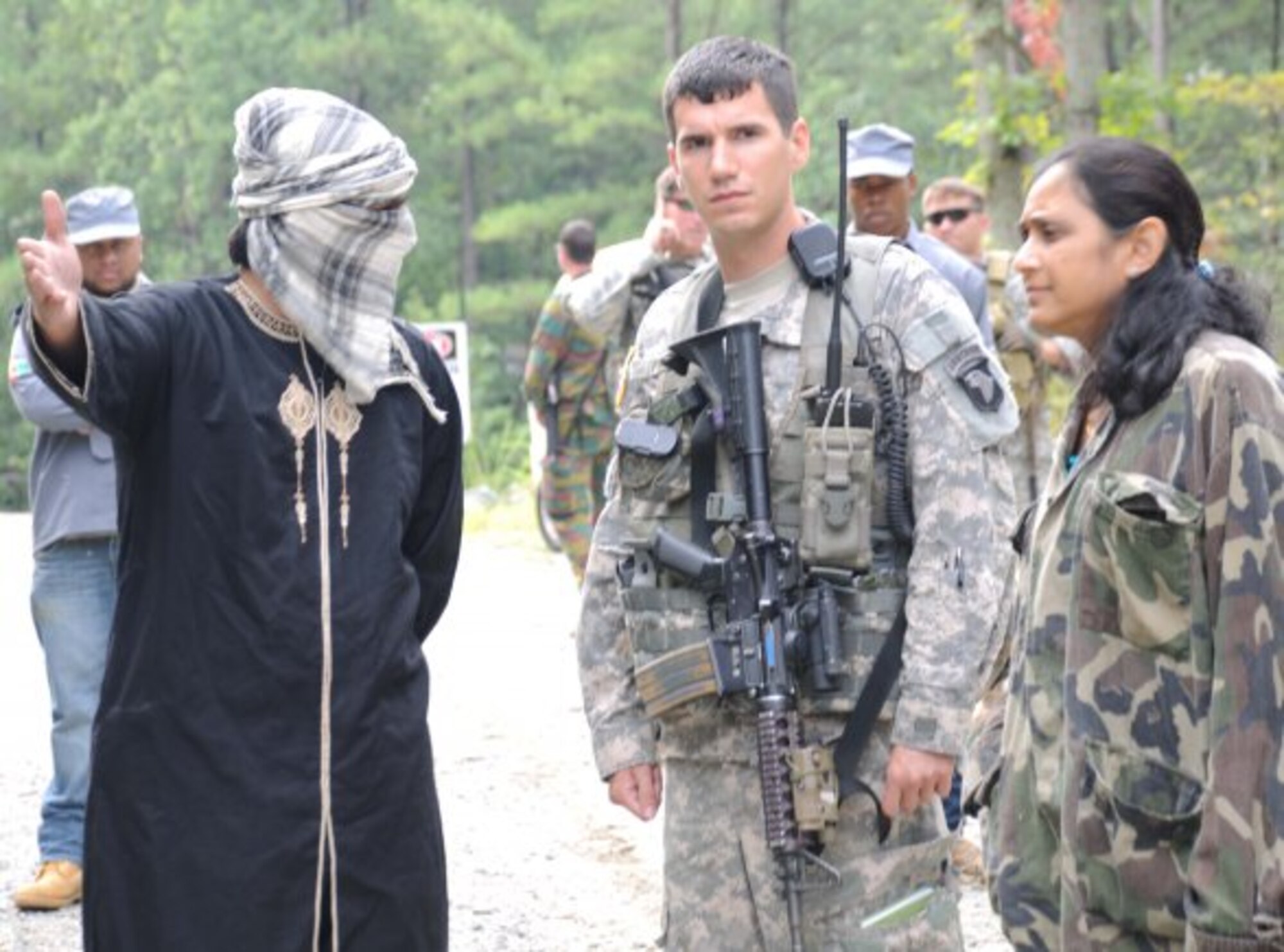 An AWALP student and his translator are given a tour of a village that had been under attack during the training scenario. (U.S. Army courtesy photo/Released)