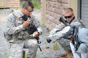 Two Asymmetric Warfare Adaptive Leader Program students try to question a "foreign national" to gather information about the area during a training scenario Aug. 21 at Fort A.P. Hill, Va. (U.S. Army courtesy photo/Released)