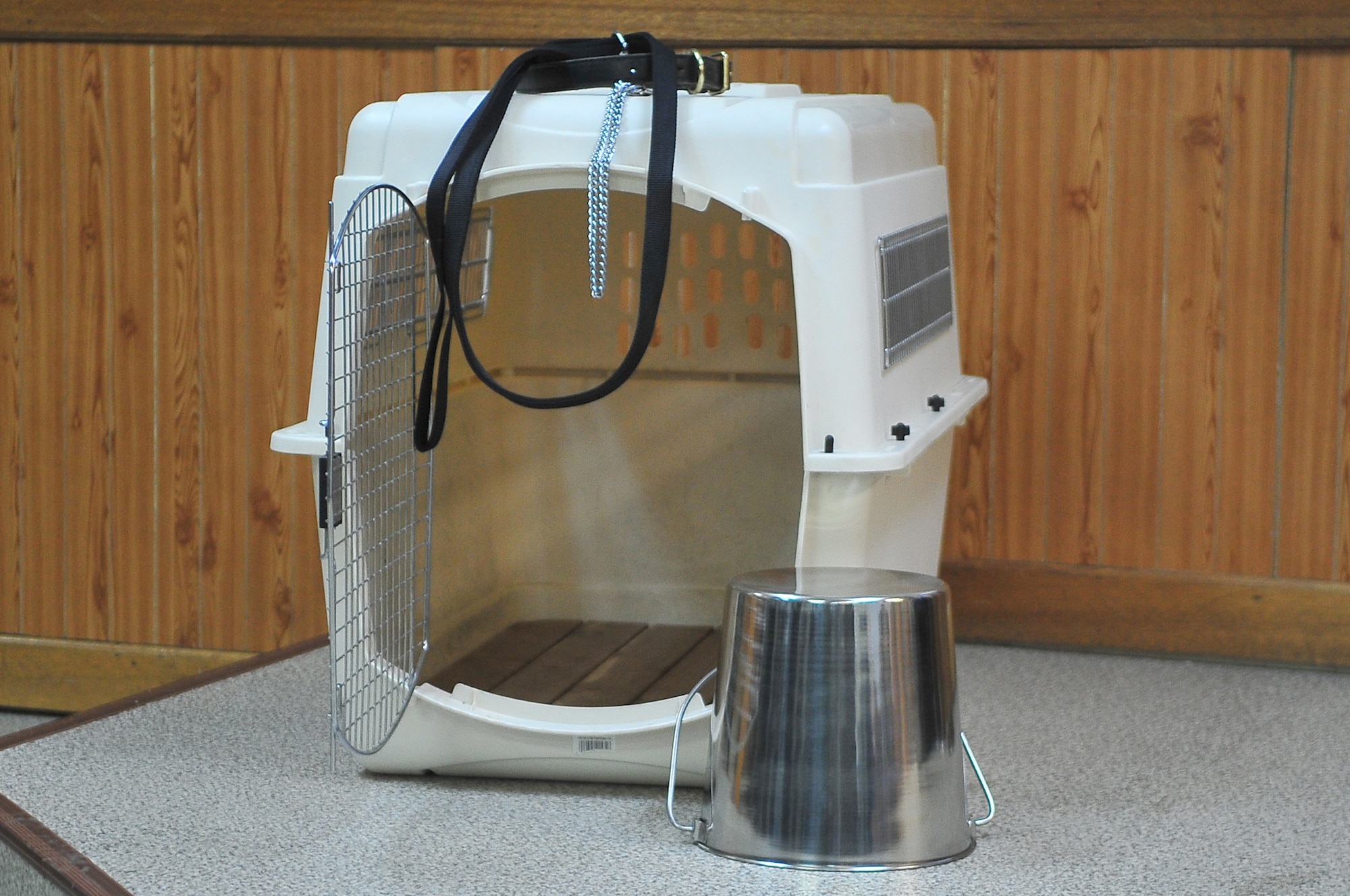 A lone kennel representing the life and contributions of military working dog CChaos sits solemnly during a commemoration ceremony Dec.20, 2012. CChaos served 10 years with the 51st Security Forces Squadron before passing on Nov. 2, 2012. (U.S. Air Force/Tech. Sgt. Raymond Mills) 