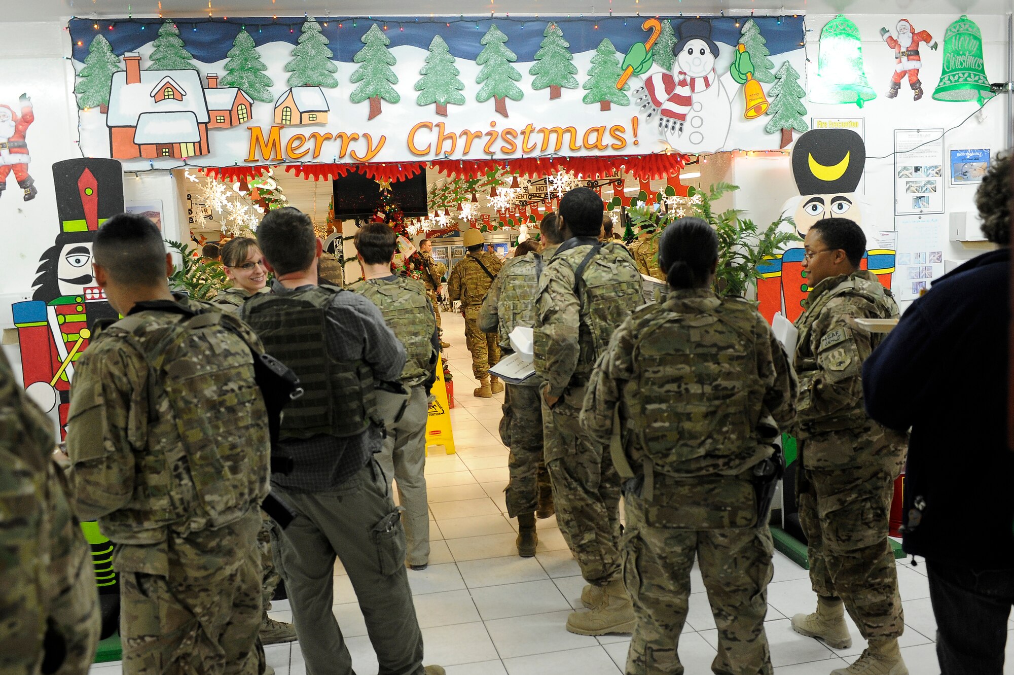 Servicemembers line up for their holiday meal at the dining facility on Bagram Airfiled, Afghanistan, Dec. 25, 2012.  Squadron and wing leadership served meals throughout the holidays to boost the morale of the servicemen and women. (U.S. Air Force photo/Senior Airman Chris Willis)
