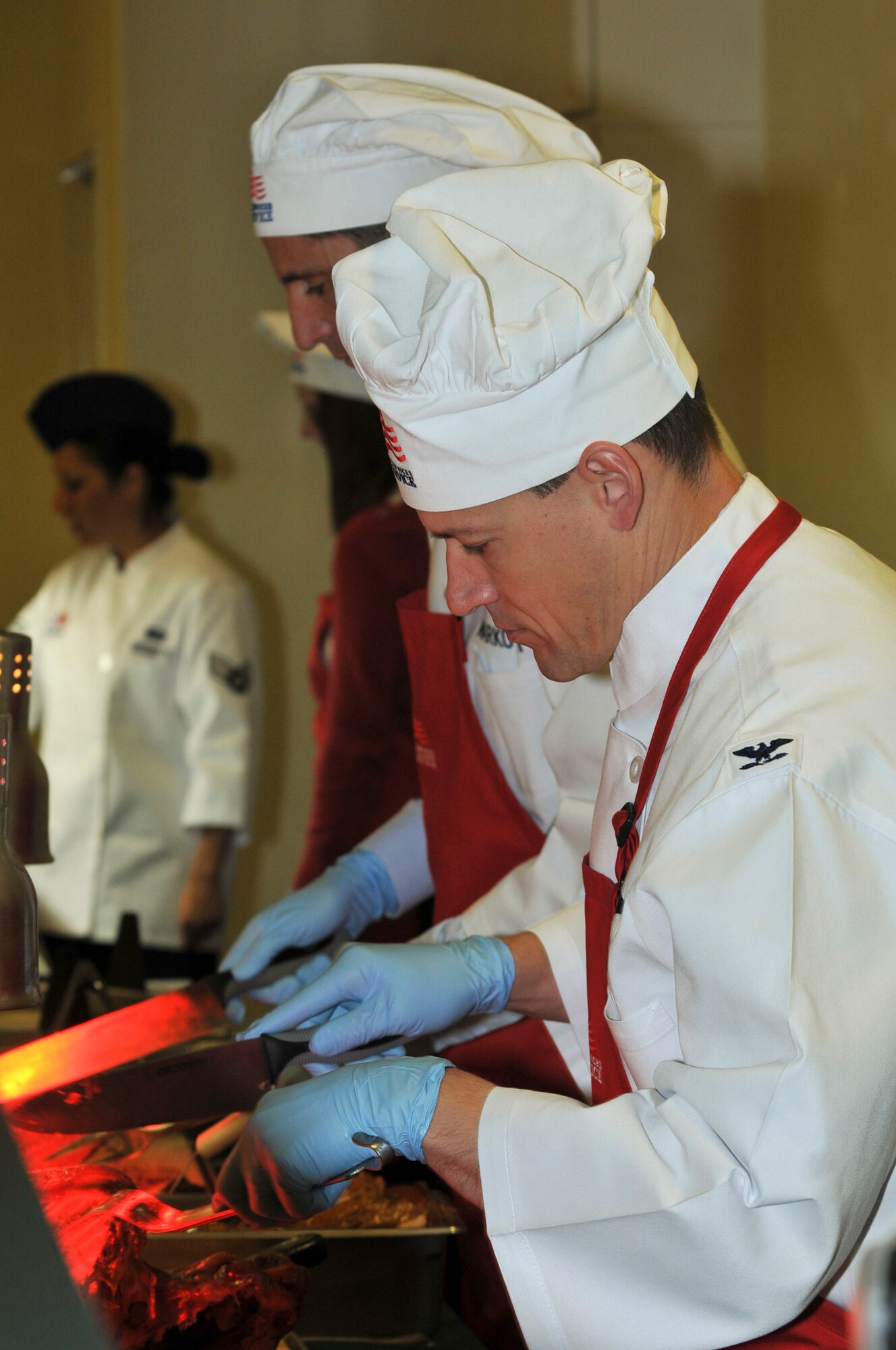 U.S. Air Force Col. Peter Milohnic, 18th Operations Group commander, carves a turkey for Airmen at the Marshal Dining Facility on Kadena Air Base, Japan, Dec. 25, 2012. Approximately 30 members of Kadena’s leadership and their families served various Christmas dishes to Airmen, Soldiers and Marines and wish them a happy holiday.  (U.S. Air Force photo/Airman 1st Class Keith James)