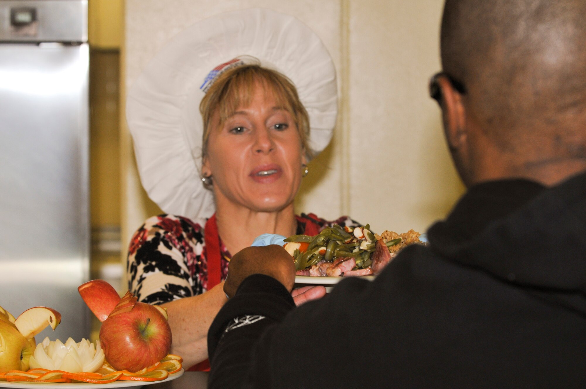 Kati Molloy, wife of U.S. Air Force Brig. Gen Matt Molloy serves a Christmas meal to Airmen at the Marshal Dining Facility on Kadena Air Base, Japan, Dec. 25, 2012. Approximately 30 members of Kadena’s leadership and their families came to serve various dishes to Airmen, Soldiers and Marines and wish them a happy holiday. (U.S. Air Force photo/Airman 1st Class Keith James)