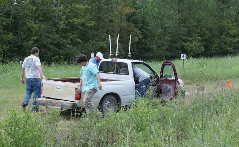 Team members check the remote-piloted truck before the evaluation of protective systems.
