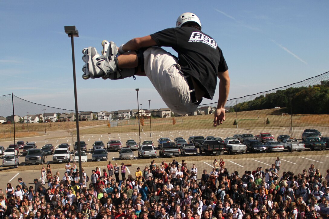 Inline skater Eito Yasutoko soars above a crowd of Shakopee High School students during a stop on the 2011 ASA Fall High School Tour Sept. 28. Recruiters from the Burnsville, Minn., office also attended the performance and held a pull-up and flexed-arm hang challenge. For additional imagery from the event, visit www.facebook.com/rstwincities.