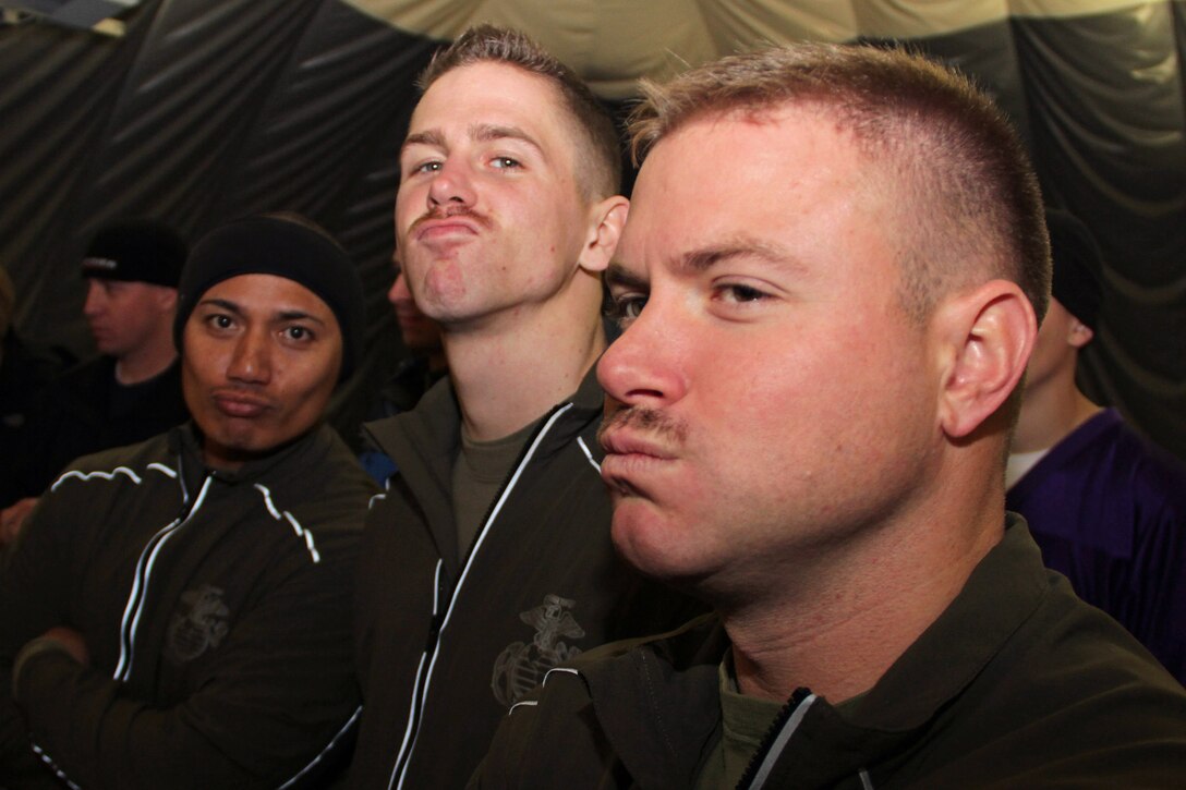Sgt. Jeremias Orden, Sgt. Jacob Bucinski and Staff Sgt. Paul Schmotter show off their mustaches during the Recruiting Station Twin Cities annual flag football tournament at the St. Croix Valley Recreational Center Nov. 18. The Rochester, Minn., recruiters were among 30 people who grew out their facial hair to promote early cancer detection and ultimately reduce the number of preventable deaths.