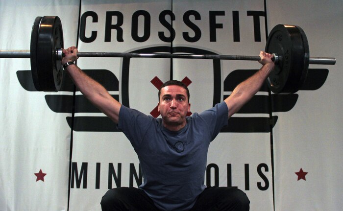 Former infantry officer Mike Jones, owner of CrossFit Minneapolis and CrossFit St. Paul, performs a snatch demonstration for Marines attending a three-day training seminar. More than 20 Marines with Recruiting Station Twin Cities attended the class to enhance fitness levels within the command. Jones, a Springfield, Va., native, served with 2nd Battalion, 8th Marine Regiment.  For additional imagery from the event, visit www.facebook.com/rstwincities.