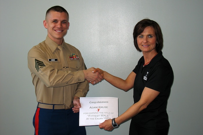 Sgt. Adam Kruse, 26, from Huron, S.D.,  receives a certificate March 9 from Stephanie Winkel, senior fitness coordinator at the Eagan, Minn., YMCA, for being named "Fittest Male." Kruse earned his new title by completing the YMCA Fitness Challenge with the fastest time. The fitness course consisted of three rounds of 21 kettle-bell swings, 15 push-ups and nine burpees, also known as  bend-and-thrusts. Kruse, a recruiter out of the Woodbury, Minn., office, crossed the finish line in 2:26.