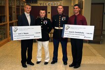 Recruiting Station Twin Cities Commanding Officer Maj. Kenneth Gawronski and Eau Claire, Wis., recruiter Sgt. Cody Stauner present Levi Nayes and Jacob Zwiefelhofer with a Naval Reserve Officers Training Corps Scholarship during the Bloomer High School awards ceremony May 23. Ninety-seven students made up the Bloomer High School 2012 graduating class. Of those who qualified for the scholarship, 300 were accepted nation-wide. Only one other school in 9th Marine Corps District received two scholarships.