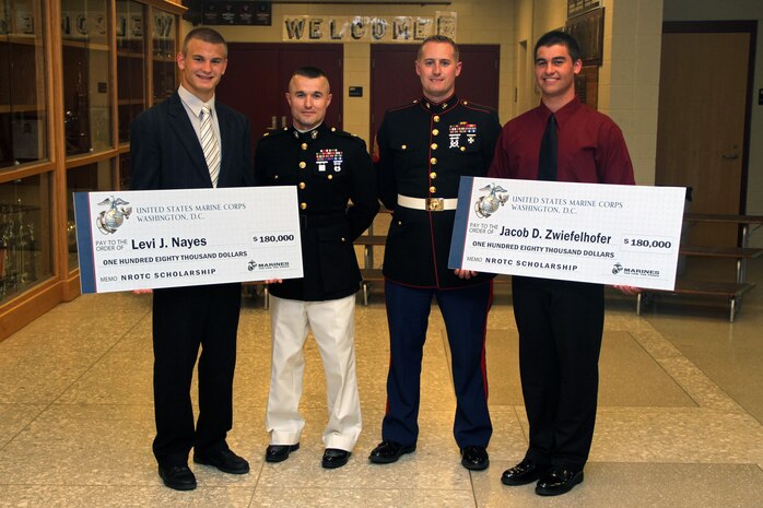 Recruiting Station Twin Cities Commanding Officer Maj. Kenneth Gawronski and Eau Claire, Wis., recruiter Sgt. Cody Stauner present Levi Nayes and Jacob Zwiefelhofer with a Naval Reserve Officers Training Corps Scholarship during the Bloomer High School awards ceremony May 23. Ninety-seven students made up the Bloomer High School 2012 graduating class. Of those who qualified for the scholarship, 300 were accepted nation-wide. Only one other school in 9th Marine Corps District received two scholarships.