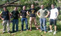 Alexander Stensland, Chase Ellis, Jake Turck, Andrew Morris, Sgt. Joshua Draveling and Joshua Mann prepare to remove debris after thunderstorms knocked down several trees. Marines and poolees with Recruiting Substation Burnsville recently volunteered to spend their weekend clearing broken branches and split tree trunks.  