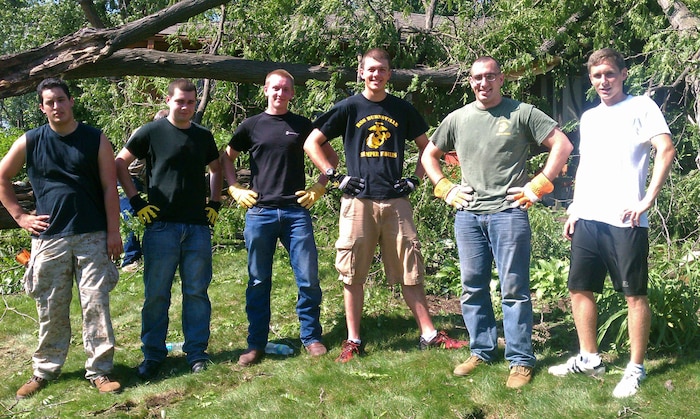 Alexander Stensland, Chase Ellis, Jake Turck, Andrew Morris, Sgt. Joshua Draveling and Joshua Mann prepare to remove debris after thunderstorms knocked down several trees. Marines and poolees with Recruiting Substation Burnsville recently volunteered to spend their weekend clearing broken branches and split tree trunks.  