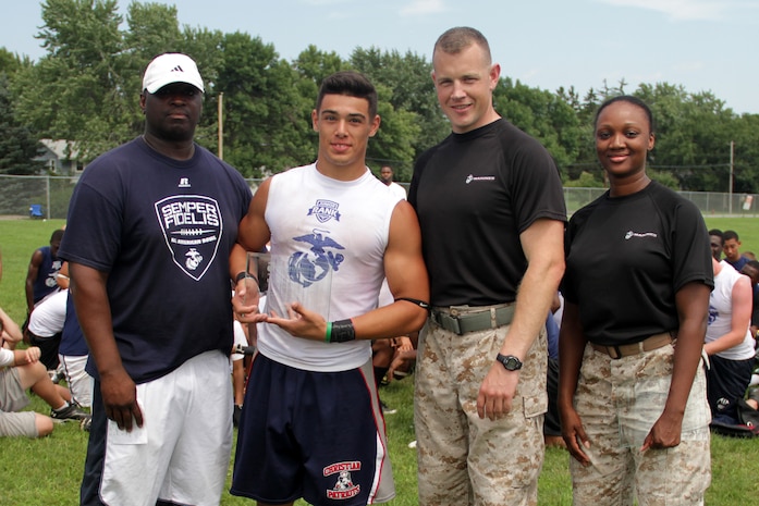 Recruiting Station Twin Cities Executive Officer Capt. Timothy O'Neil and Recruiting Substation Coon Rapids' Staff Sgt. Tyanna Tolson present Anastacio VandenBosch-Romo with an Excellence in Leadership Award at the Minneapolis Diamond Flight Camp July 22. Junior Rank coaches selected Romo to receive the award because he displayed great character and leadership throughout the camp. Romo, 16, will be a junior at Henry Sibley High School.