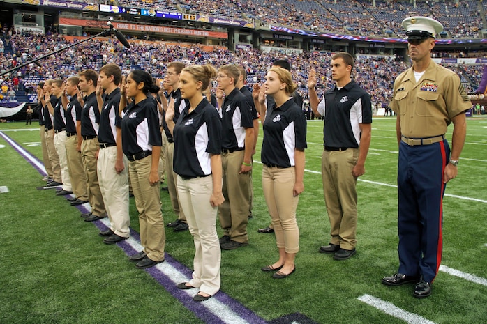 Twenty-four aspiring Marines with Recruiting Station Twin Cities take the oath of enlistment at the Metrodome before the Minnesota Vikings battle the Jackson Jaguars on Sept. 9. All 24 of the Vikings Platoon members will ship off to boot camp Sept. 10-11. For additional imagery from the event, visit www.facebook.com/rstwincities. 