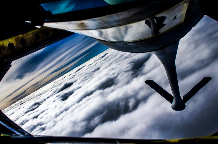 A KC-135 Stratotanker banks while preparing to refuel an F-15 Eagle during an evening training sortie near Kadena Air Base, Japan, Dec. 27, 2012. The 909th Air Refueling Squadron provides combat ready KC-135 tanker aircrews to support peacetime operations in all levels of conflict in the Pacific theater. (U.S. Air Force photo/Airman 1st Class Tyler Prince)