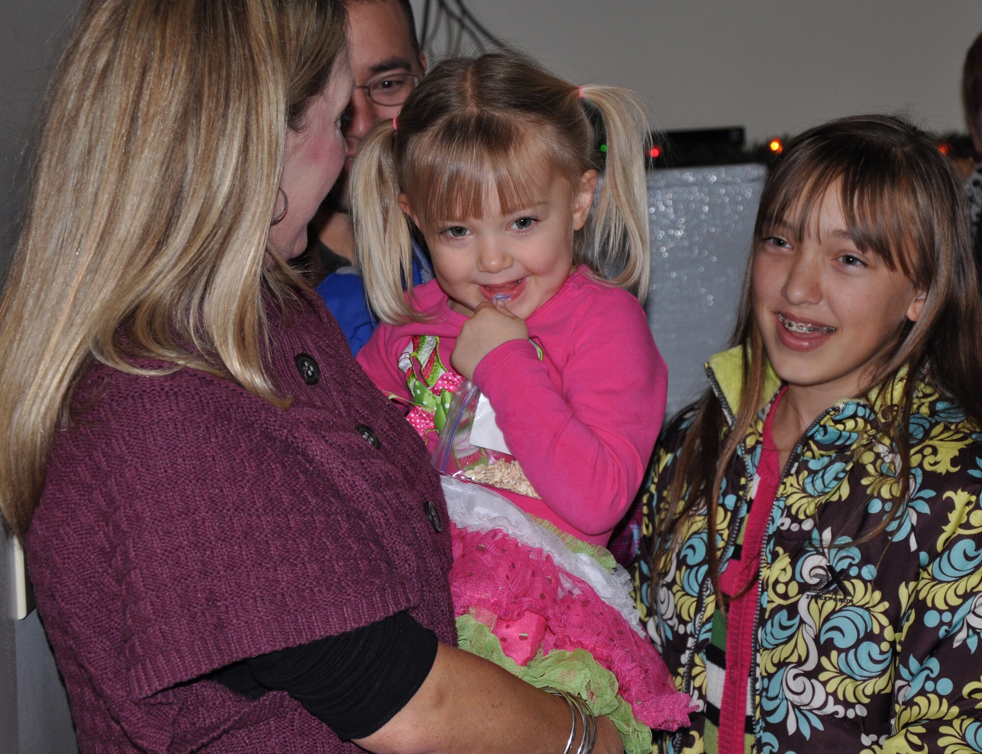 Beth Stegeman and her daughter react to Santa Claus's voice when he called the 7th Space Warning Squadron radar tower on his high-tech satellite phone attached to his sleigh. Children and families of Team Beale are invited up to the tower every year to help track Santa Claus around the world on Christmas Eve. (U.S. Air Force photo by 2nd Lt. Siobhan G. Bennett/Released)