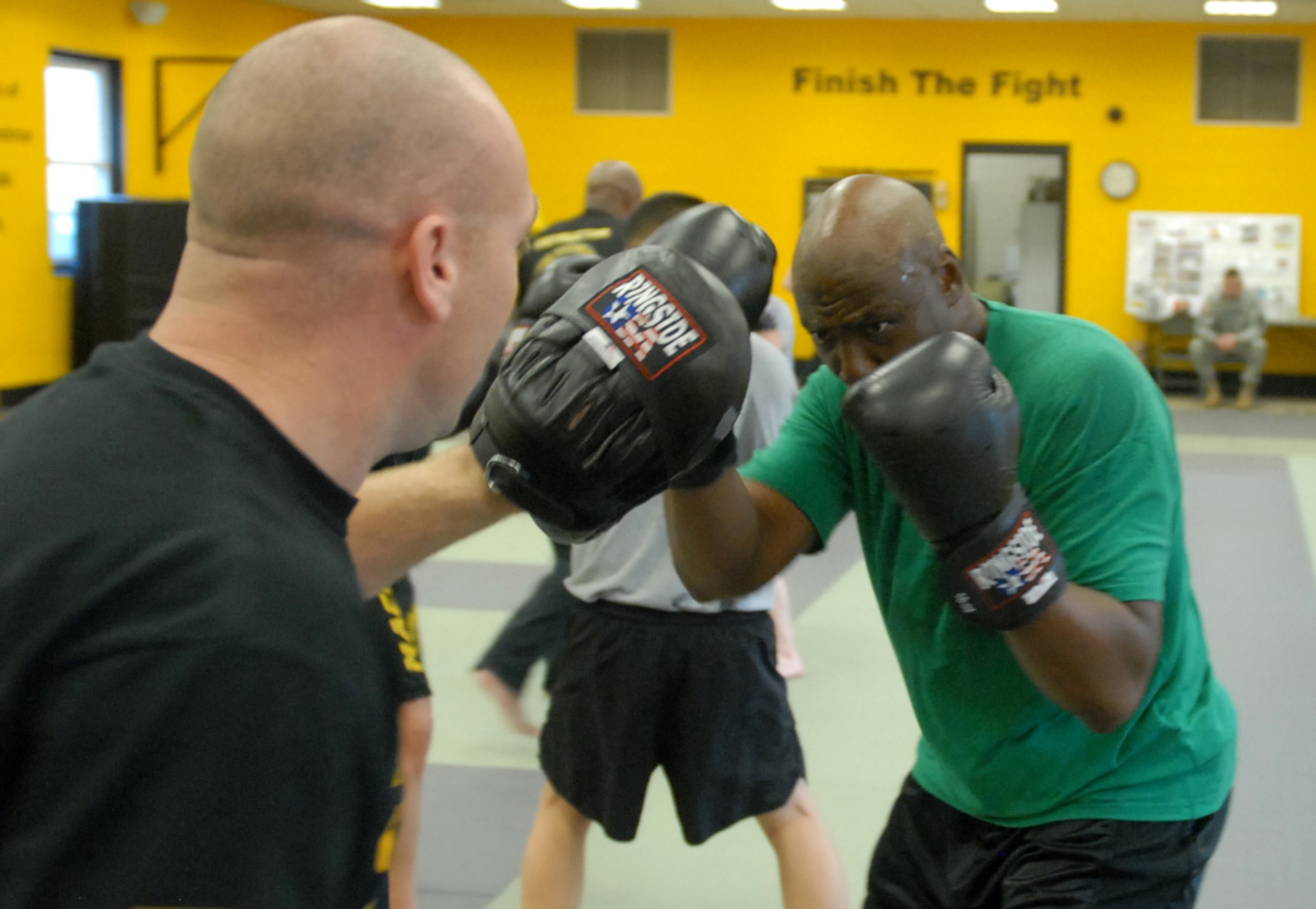 Lieutenant Col. Hugh Elmore (right), battalion commander of the 1st Brigade, 309th Training Support Battalion, performs boxing techniques against Modern Army Combatives Program Instructor Staff Sgt. Steven Blashfield during training at Joint Base McGuire-Dix-Lakehurst, N.J., Dec. 20, 2012. Students were taught fighting techniques they will use in real-life fighting situations. (U.S. Army photo by Sgt. Jessi McCormick/Released)