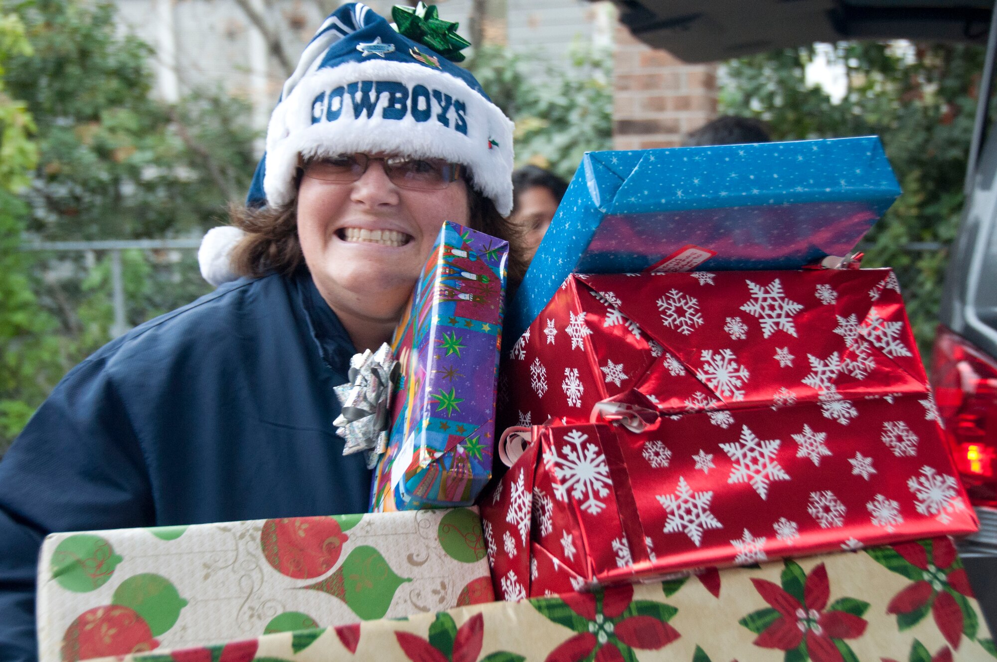 Ms. Tina Brewster, a course developer with the 737th Training Support Squadron helped carry packages in during this year's Operation Grayson Square. Military Training Instructors and other members of the 737th Training Group played Santa at a local skilled nursing facility delivering gifts to 84 residents this season. The 737th Training Group has been "elfing it up" with Operation Grayson Square since 1999. (U.S. Air Force Photo/Melinda Mueller) 

