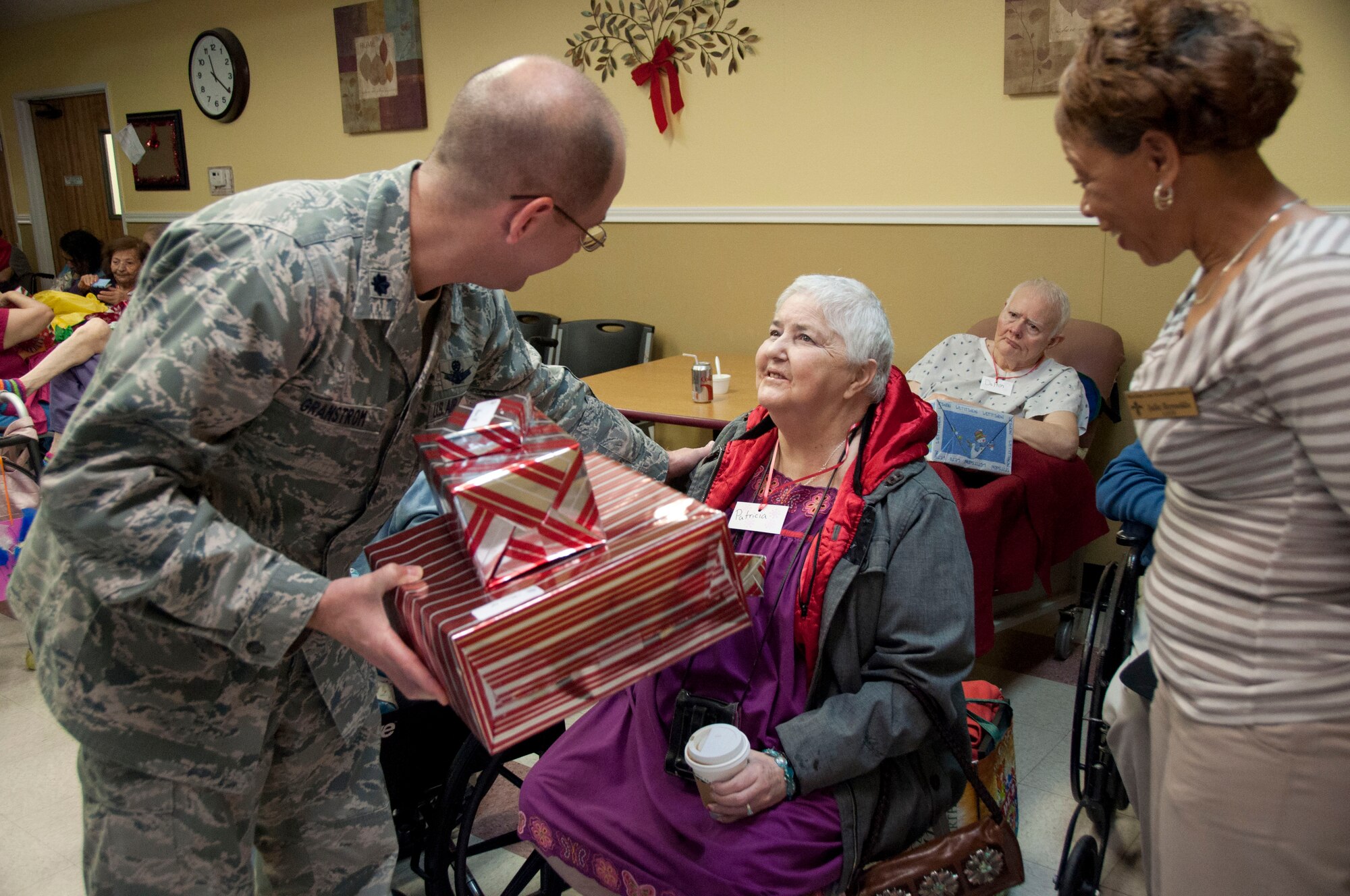 Lt. Col. Jared anstrom, commander of the 737th Training Support Group passed out a few of the gifts during Operation Grayson Square. Military Training Instructors and other members of the 737th Training Group played Santa at a local skilled nursing facility delivering gifts to 84 residents this season. The 737th Training Group has been "elfing it up" with Operation Grayson Square since 1999. (U.S. Air Force Photo/Melinda Mueller) 

