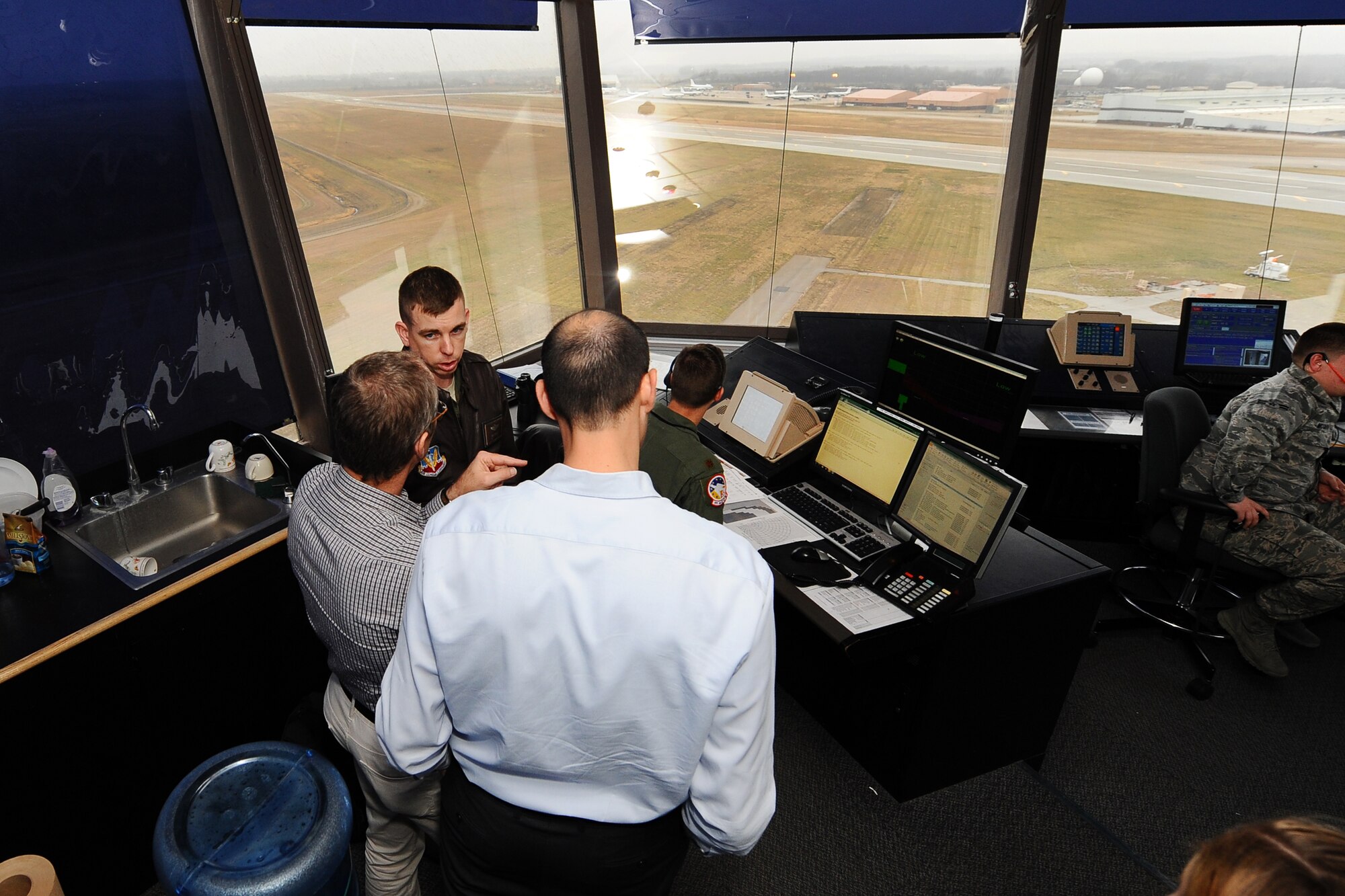 U.S. Air Force Maj. Dan Converse, 55th Wing chief of flight safety, gives two Israeli Air Force officers a tour of the Offutt control tower Dec. 19 at Offutt AFB, Neb. The two IAF members were looking to gain a better understanding of the base’s MERLIN Aircraft Birdstrike Avoidance Radar System that is used to protect aircraft from local bird populations. (U.S. Air Force Photo by Josh Plueger/Released)