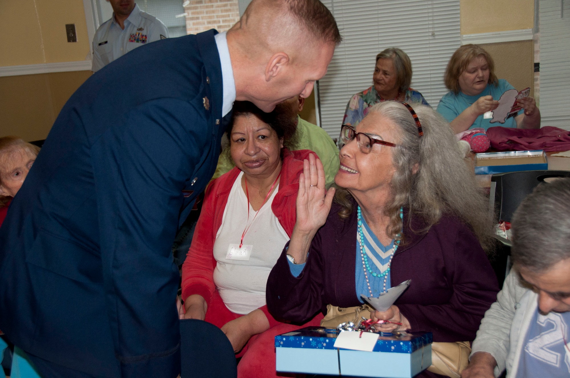 Lt. Col. Jeffrey Greenwood, commander of the 323rd Training Squadron, visited with residents during Operation Grayson Square. Military Training Instructors and other members of the 737th Training Group played Santa at a local skilled nursing facility delivering gifts to 84 residents this season. The 737th Training Group has been "elfing it up" with Operation Grayson Square since 1999. (U.S. Air Force Photo/Melinda Mueller) 

