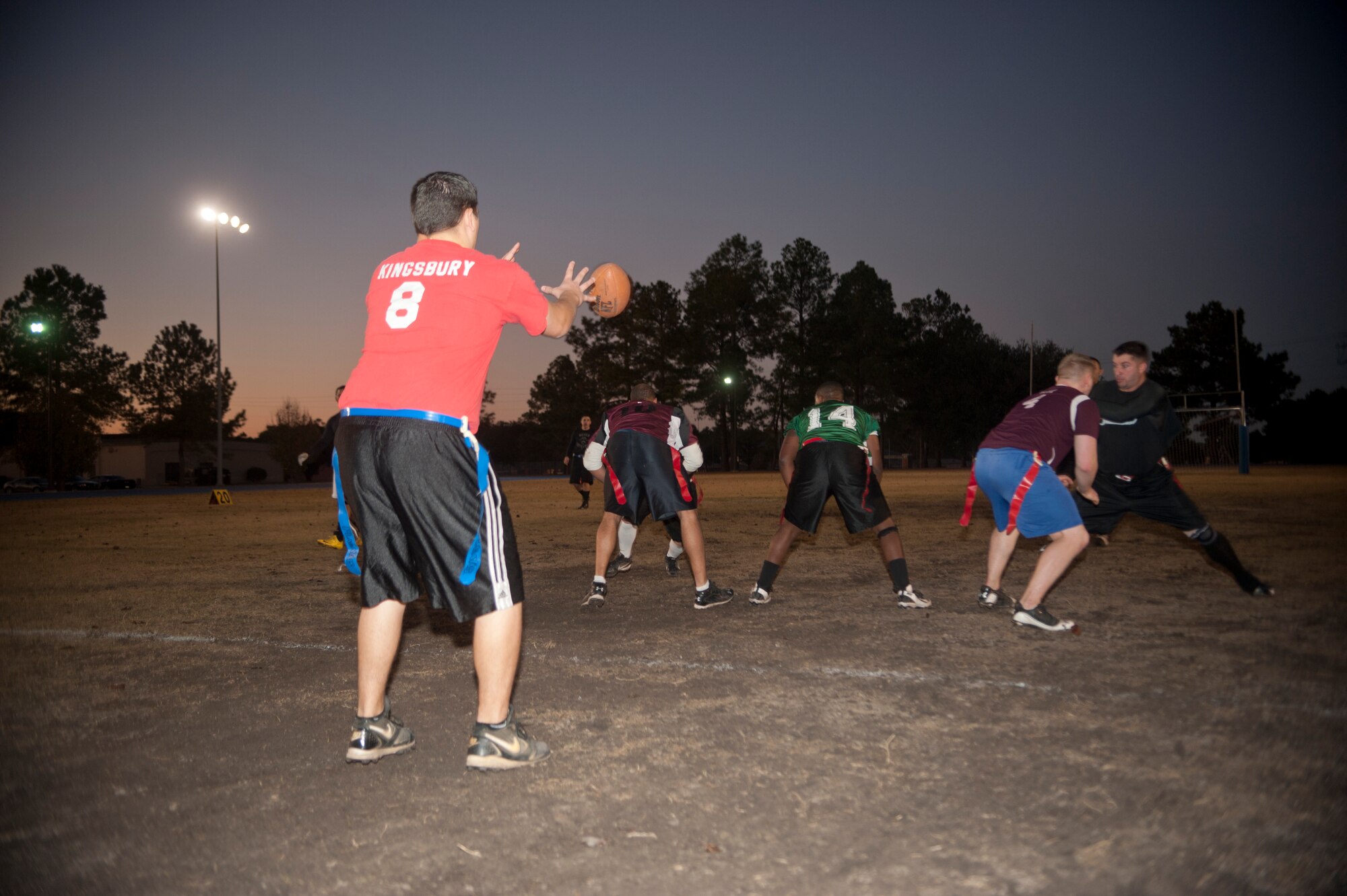 Christopher Kingsbury, 23d Medical Group quarterback, hikes the ball during an intramural flag football champion game at Moody Air Force Base, Ga., Dec. 18, 2012. The 23d MDG played against the combined team of the 23d and 347th Operations Support Squadrons, who they lost to in last year’s flag football championship. (U.S. Air Force photo by Airman Paul Francis/Released)
