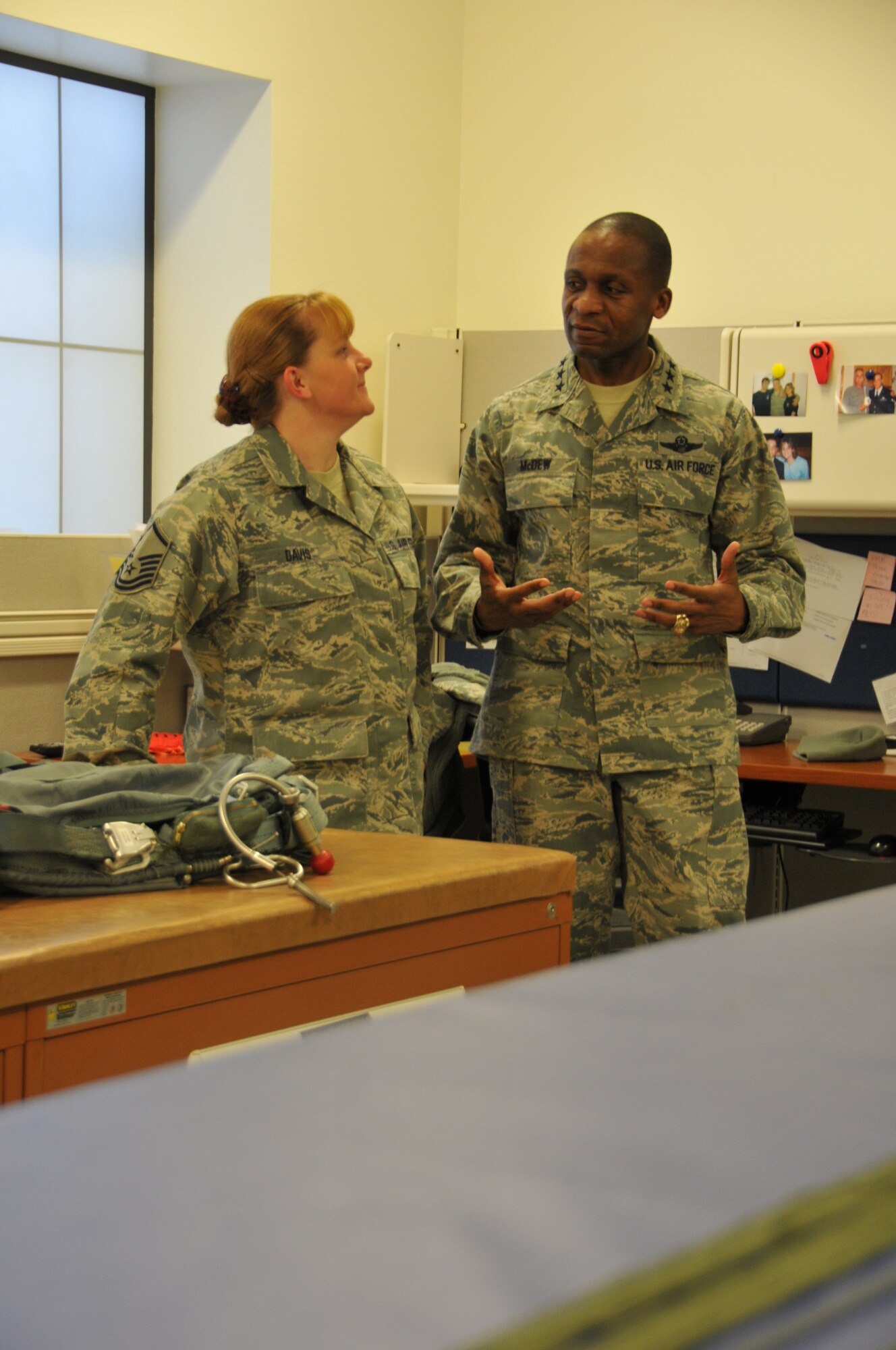 Lt. Gen. Darren W. McDew, 18th Air Force commander, visits with Master Sgt. Janet Davis while touring Wyoming Air National Guard facilities Dec. 18, 2012. The general also held an all call for Airmen where he addressed members of the wing and answered questions. (U.S. Air Force photo by Capt. Rusty Ridley)