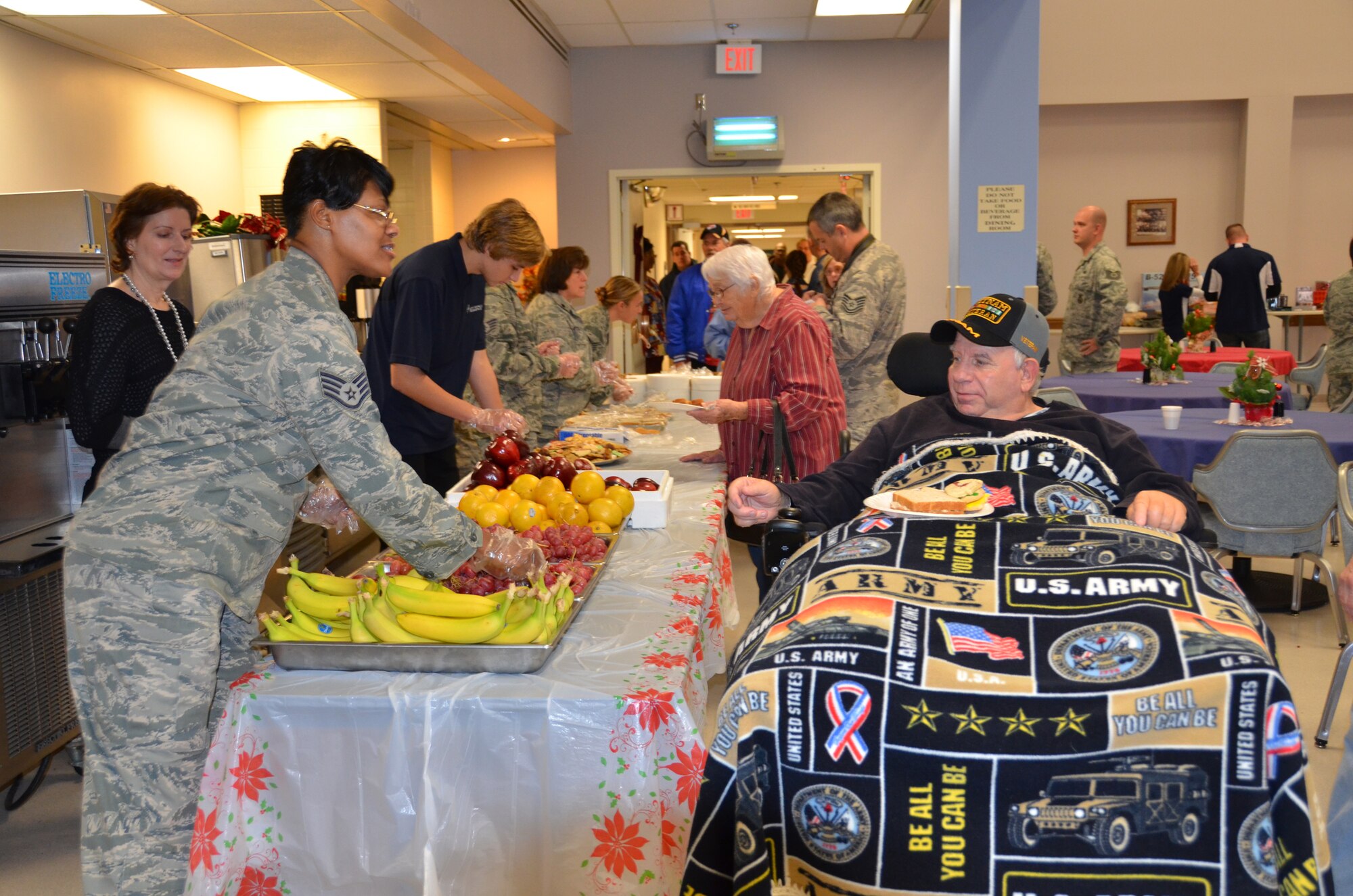 WRIGHT-PATTERSON AIR FORCE BASE, Ohio – Staff Sgt. Jawahna Hollins, 445th Airlift Wing executive assistant to the 445th AW command chief, serves a Vietnam veteran some fruit at the Dayton VA Medical Center’s annual Christmas party Dec. 1, 2012. The party is sponsored every year by the Kittyhawk chapter of the Air Force Sergeant’s Association and supported by gifts, monetary donations and volunteers from the wing. (U.S. Air Force photo/Capt. John Stamm)   