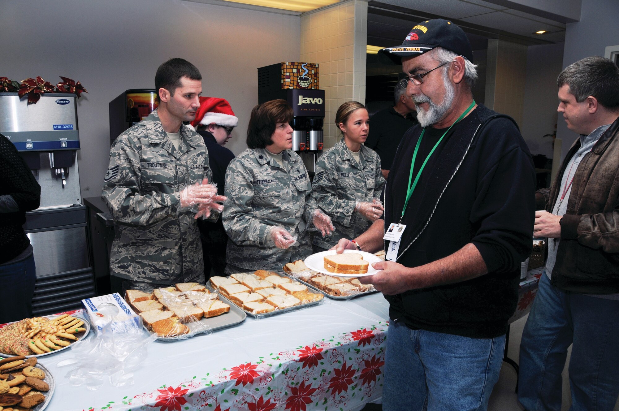 WRIGHT-PATTERSON AIR FORCE BASE, Ohio - 445th Aeromedical Staging Squadron reservists Staff Sgt. Matthew Troutwine, aerospace medicine services helper, Lt. Col. Kathleen Stierwalt, clinical nurse, and Staff Sgt. Melissa Miller, aerospace medicine services journeyman, serve lunch to veterans during a visit to the Dayton Veteran’s Affairs Medical Center Christmas party Dec. 1, 2012. (U.S. Air Force photo/Tech. Sgt. Anthony G. Springer)   