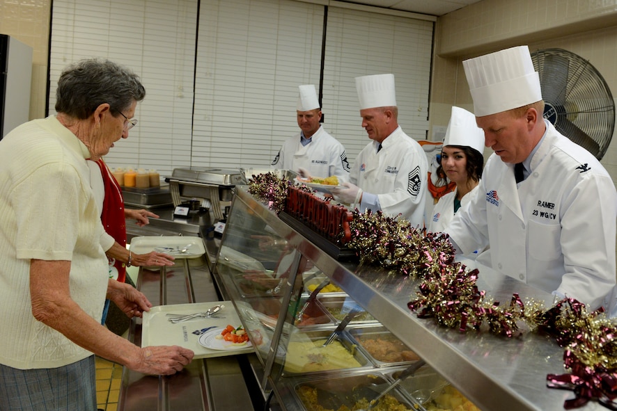 Base leadership and their families serve Christmas lunch at the Georgia Pines Dining Facility on Moody Air Force Base, Ga., Dec. 25, 2012. The lunch service consisted of turkey, ham, roast beef, and all the fixings of a traditional Christmas dinner. (U.S. Air Force photo by Staff Sgt. Joshua J. Garcia/Released)