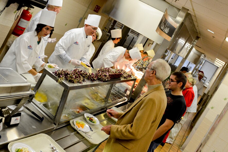 Base leadership and their families serve Christmas lunch at the Georgia Pines Dining Facility, Dec. 25, 2012, at Moody Air Force Base, Ga.  Leadership took shifts serving patrons during the two and a half hour lunch service.  (U.S. Air Force photo by Staff Sgt. Joshua J. Garcia/Released)