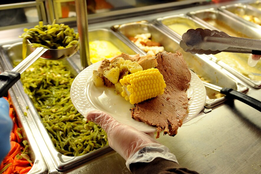 Potatoes, roast beef and corn-on-the-cob round out an Airman’s plate as he is served Christmas dinner by 55th Wing leadership at the Ronald L. King Dining Facility Dec. 25, Offutt Air Force Base, Neb.  Every year wing leadership volunteers their time to ensure those Airmen, unable to travel home for the holidays, have a warm Christmas dinner.  (U.S. Air Force Photo by Josh Plueger/Released)