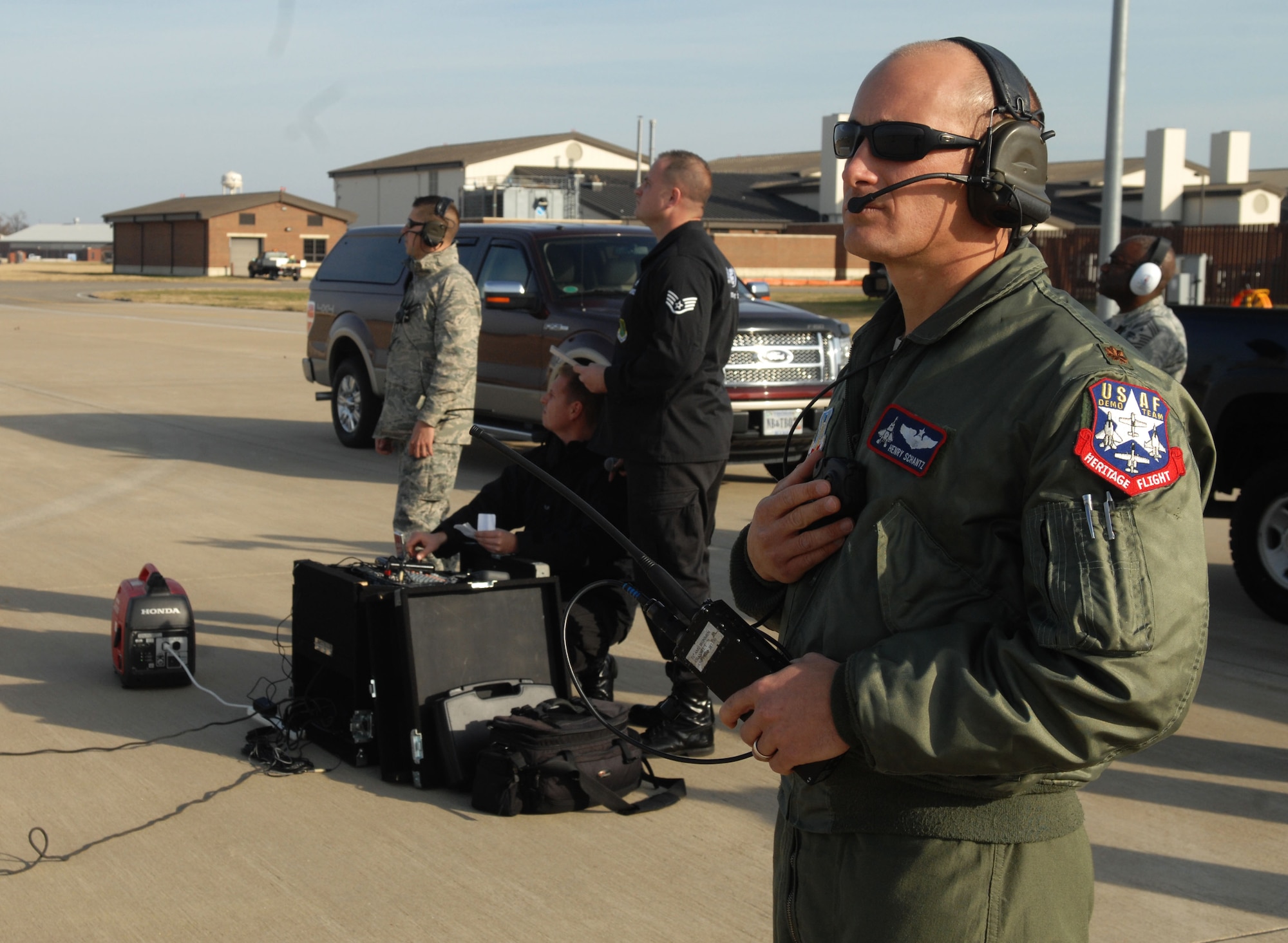 Maj. Henry Schantz, the preceding Air Force F-22 Raptor demonstration pilot, trains his replacement pilot, Capt. Patrick Williams, during an exercise at Langley Air Force Base, Va., Nov. 30. The demo team switches a few members every demo season to allow Airmen a chance to display their talent and add new perspectives to the mission. (U.S. Air Force photo by Airman 1st Class Austin Harvill/Released)