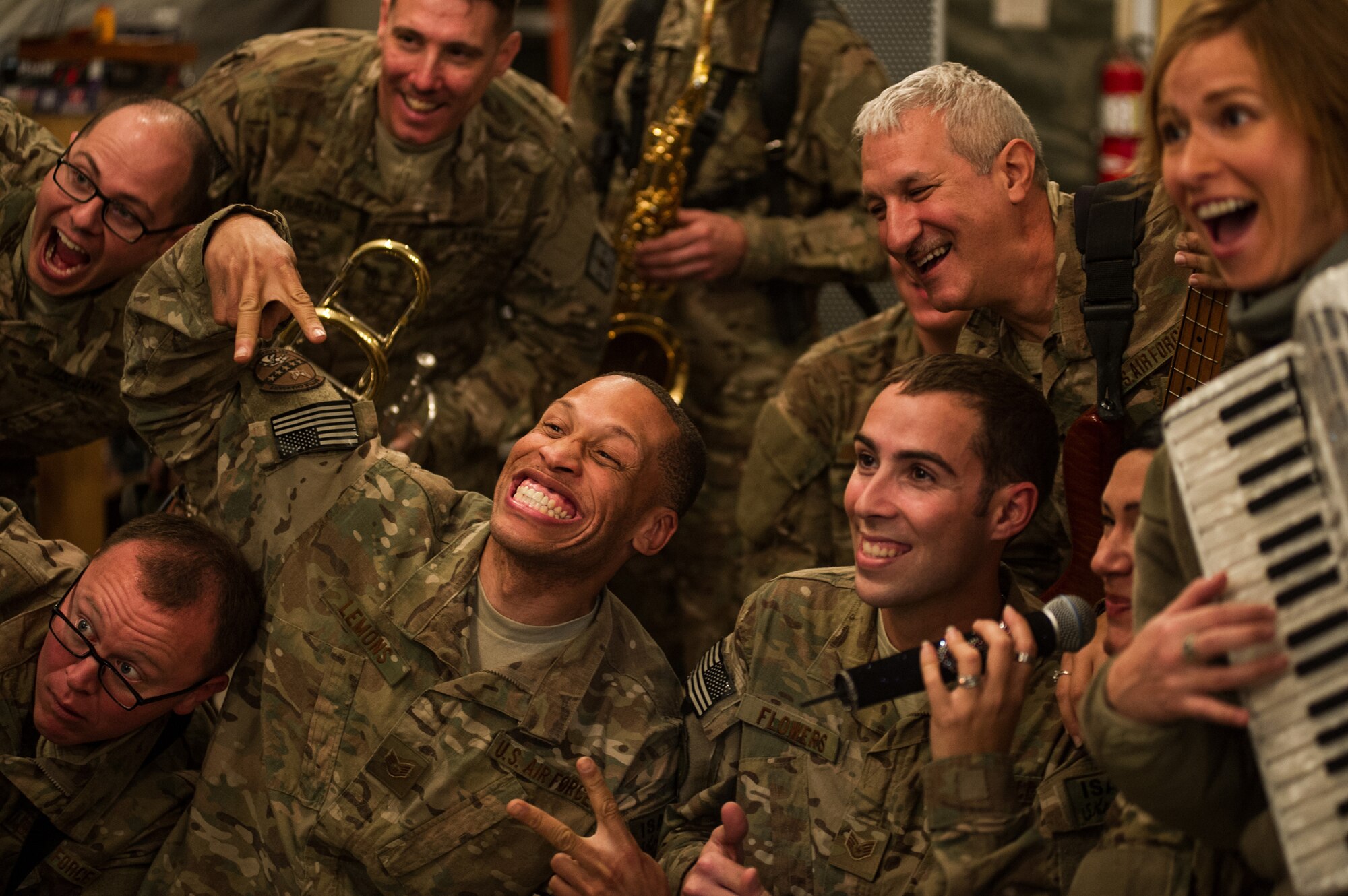 U.S. Air Forces Central Band "Total Force", takes a photo with audience members Dec. 20, 2012, at Kandahar Airfield, Afghanistan. The band had a chance to tour around base playing at several different work centers. (U.S. Air Force photo/Staff Sgt. Jonathan Snyder)