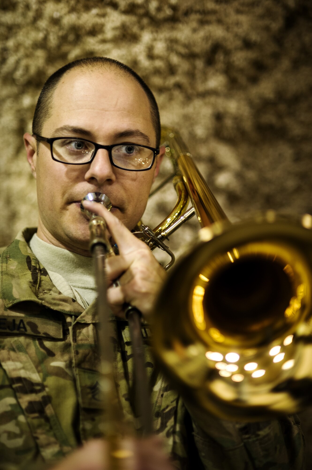 U.S. Army Staff Sgt. Brad Leja, member of U.S. Air Forces Central Band "Total Force", plays the trombone during a performance for the 451st Expeditionary Communications Squadron Dec. 20, 2012, at Kandahar Airfield, Afghanistan. Three Army musicians were integrated into the band during the holiday tour making the band truly a total force. Leja's hometown is Orlando, Fla. (U.S. Air Force photo/Staff Sgt. Jonathan Snyder)