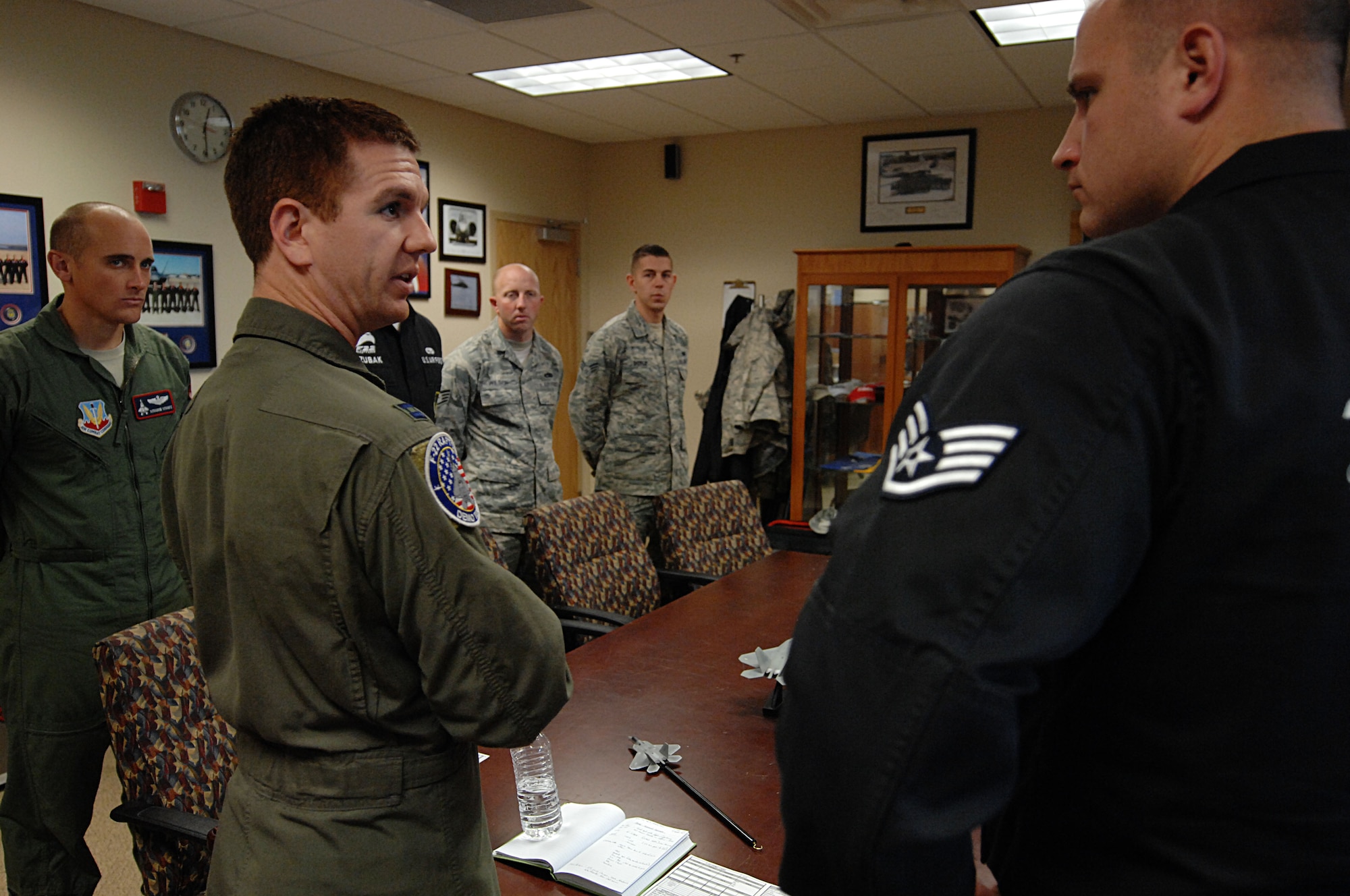 Capt. Patrick Williams, Air Force F-22 Raptor demonstration pilot, discusses his flight plan before conducting an exercise at Langley Air Force Base, Va., Nov. 30. Before every demo flight, Williams explains the routine to the team. (U.S. Air Force photo by Airman 1st Class Austin Harvill/Released)
