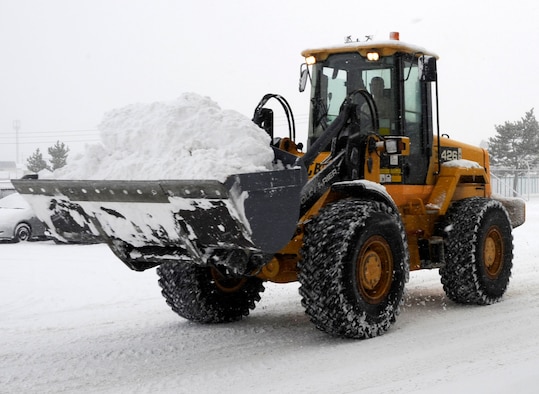 The 35th Civil Engineer Squadron snow removal team clears large amounts of snow from the collocated club parking lot Dec. 27, 2012, at Misawa Air Base, Japan. Since November, 35 CES personnel began working 24-hour operations to ensure winter weather doesn’t stop the 35th Fighter Wing’s mission. (U.S. Air Force photo/Airman 1st Class Kaleb Snay) 